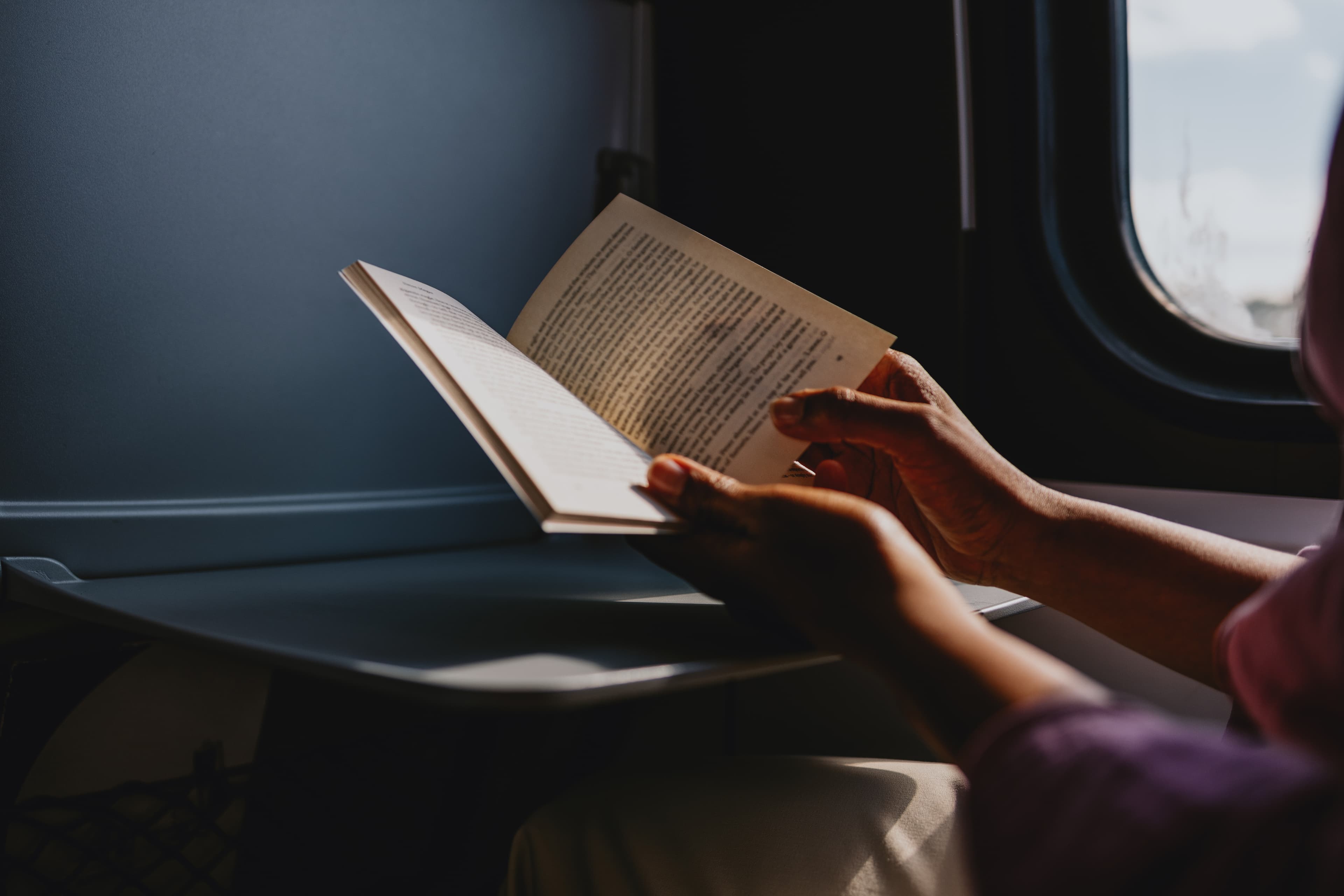 A close-up of hands holding an open book
